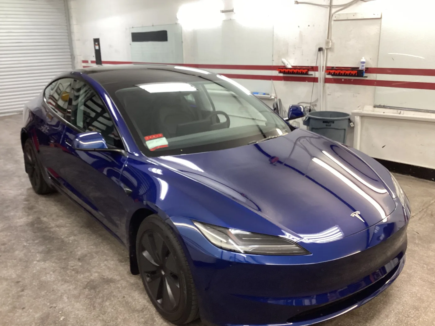 Blue Tesla with tinted windows inside Superior’s Ontario shop