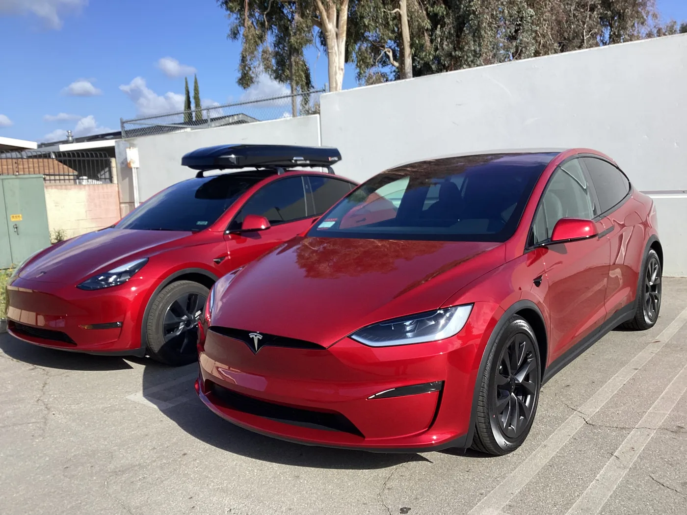 Red Tesla vehicles outside the shop — window tint photo collection